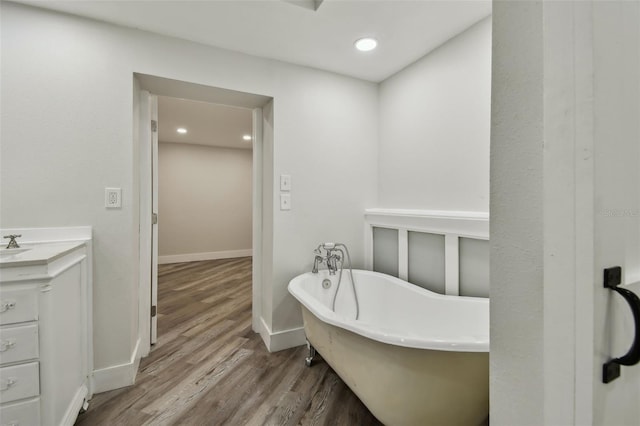 816 9th Ave SW, Largo, FL 33770 - bathroom featuring a freestanding bath, wood finished floors, vanity, baseboards, and recessed lighting