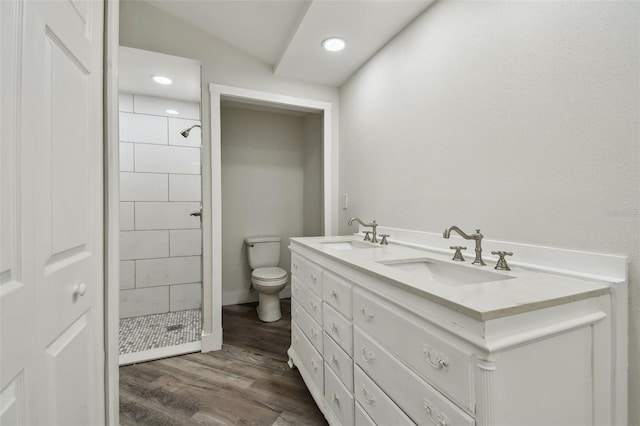 816 9th Ave SW, Largo, FL 33770 - full bathroom featuring a stall shower, wood finished floors, toilet, double vanity, and recessed lighting