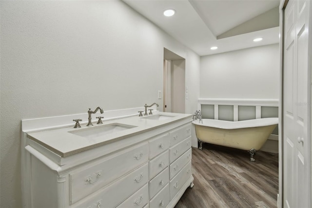 816 9th Ave SW, Largo, FL 33770 - full bathroom with recessed lighting, wood finished floors, a freestanding bath, and double vanity