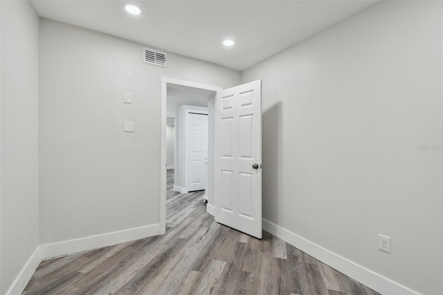 816 9th Ave SW, Largo, FL 33770 - spare room with baseboards, wood finished floors, and recessed lighting