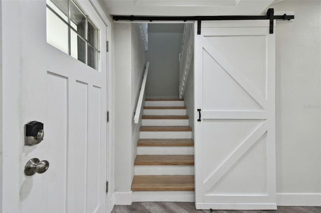816 9th Ave SW, Largo, FL 33770 - staircase with a barn door, wood finished floors, and baseboards