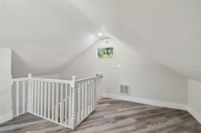 816 9th Ave SW, Largo, FL 33770 - bonus room featuring lofted ceiling, wood finished floors, baseboards, and recessed lighting