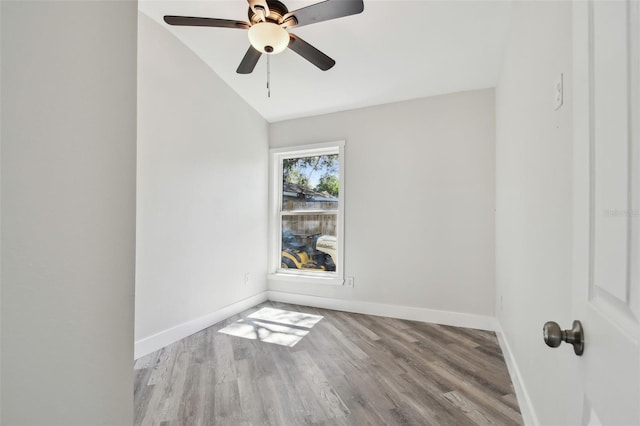 816 9th Ave SW, Largo, FL 33770 - spare room featuring vaulted ceiling, wood finished floors, baseboards, and a ceiling fan