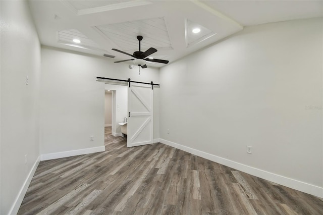 816 9th Ave SW, Largo, FL 33770 - spare room featuring ceiling fan, a barn door, wood finished floors, baseboards, and recessed lighting
