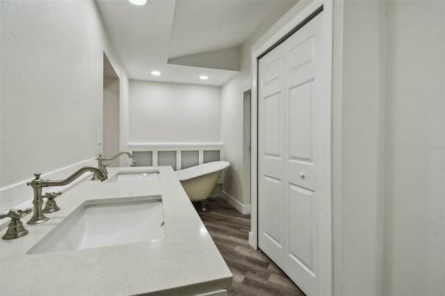 816 9th Ave SW, Largo, FL 33770 - bathroom with recessed lighting, a freestanding bath, wood finished floors, double vanity, and a closet