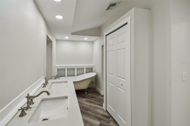 816 9th Ave SW, Largo, FL 33770 - full bathroom featuring recessed lighting, a soaking tub, wood finished floors, and double vanity
