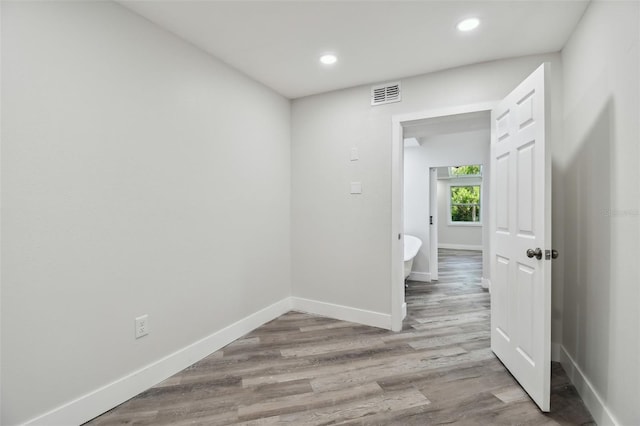 816 9th Ave SW, Largo, FL 33770 - spare room with baseboards, wood finished floors, and recessed lighting