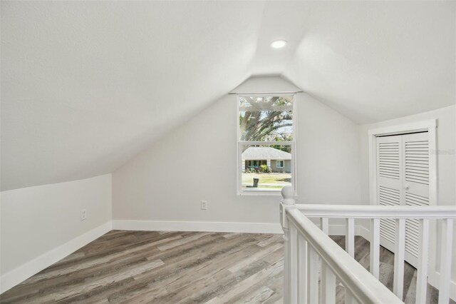 816 9th Ave SW, Largo, FL 33770 - additional living space featuring vaulted ceiling, light wood finished floors, and baseboards