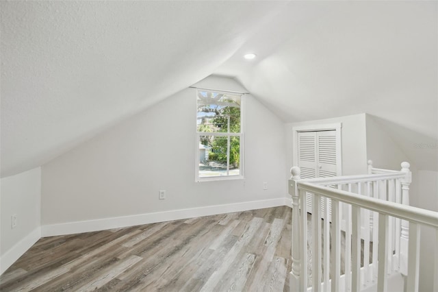 816 9th Ave SW, Largo, FL 33770 - additional living space featuring lofted ceiling, light wood-style flooring, and baseboards