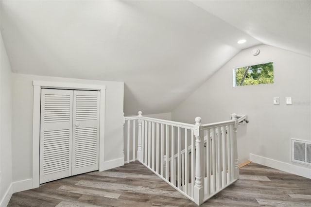 816 9th Ave SW, Largo, FL 33770 - hallway with vaulted ceiling, wood finished floors, baseboards, and an upstairs landing