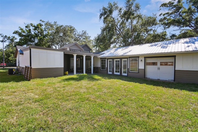 816 9th Ave SW, Largo, FL 33770 - view of front of property with a front lawn, board and batten siding, central AC unit, and metal roof
