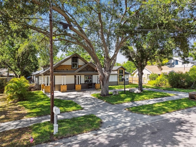 816 9th Ave SW, Largo, FL 33770 - view of front of property featuring covered porch, a front yard, and driveway