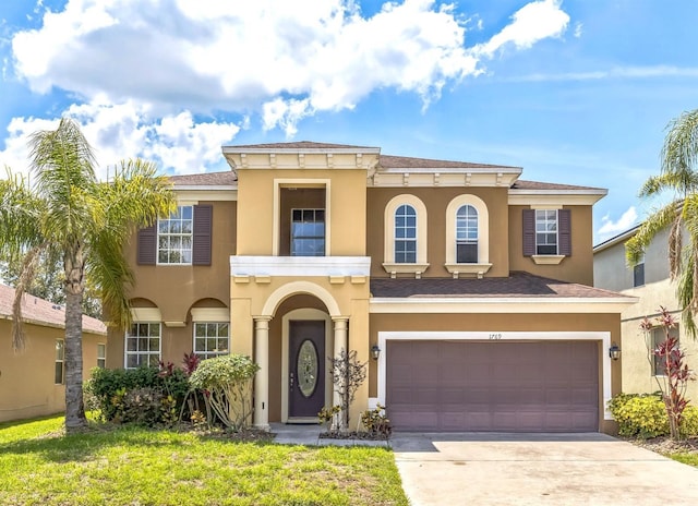 1769 Strathmore Cir, Mount Dora, FL 32757 - mediterranean / spanish house with stucco siding, concrete driveway, and a garage