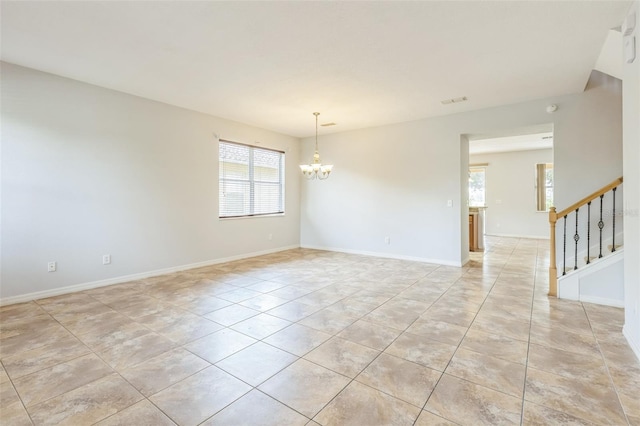 1769 Strathmore Cir, Mount Dora, FL 32757 - unfurnished room with a chandelier, light tile patterned flooring, stairs, and baseboards