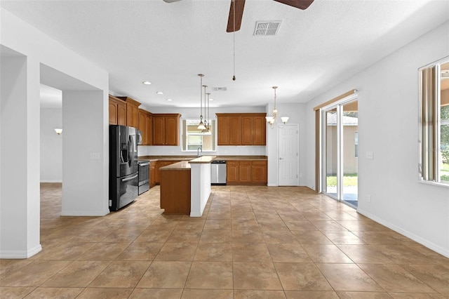 1769 Strathmore Cir, Mount Dora, FL 32757 - kitchen featuring appliances with stainless steel finishes, ceiling fan, plenty of natural light, a textured ceiling, and recessed lighting