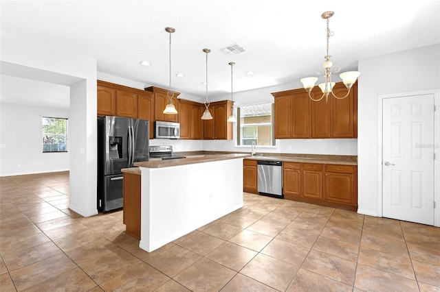 1769 Strathmore Cir, Mount Dora, FL 32757 - kitchen featuring stainless steel appliances, a chandelier, healthy amount of natural light, pendant lighting, and recessed lighting