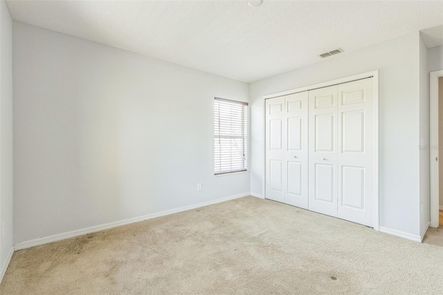 1769 Strathmore Cir, Mount Dora, FL 32757 - unfurnished bedroom with carpet flooring, baseboards, and a closet
