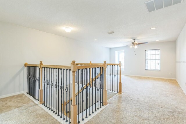 1769 Strathmore Cir, Mount Dora, FL 32757 - hall with an upstairs landing, light carpet, baseboards, recessed lighting, and a textured ceiling