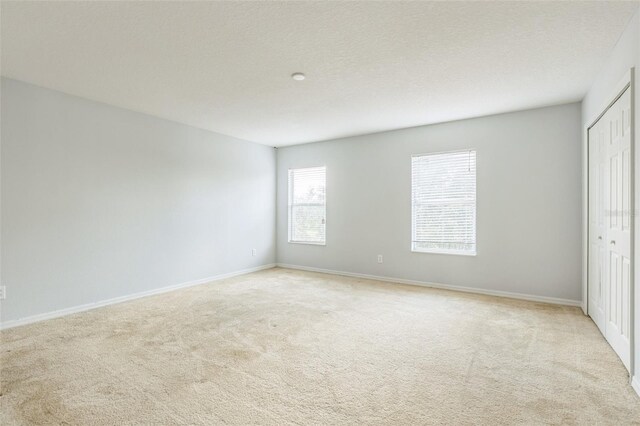 1769 Strathmore Cir, Mount Dora, FL 32757 - unfurnished bedroom featuring carpet flooring, a closet, and baseboards