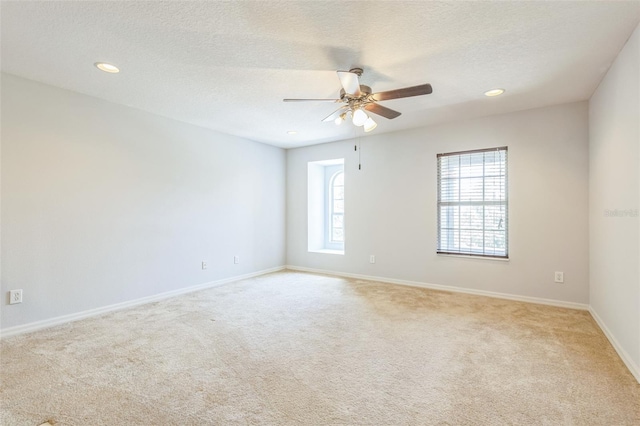 1769 Strathmore Cir, Mount Dora, FL 32757 - unfurnished room with light colored carpet, ceiling fan, baseboards, a textured ceiling, and recessed lighting