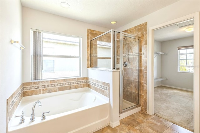 1769 Strathmore Cir, Mount Dora, FL 32757 - bathroom featuring a garden tub, a shower stall, a textured ceiling, and tile patterned flooring