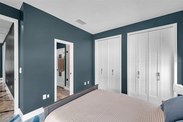 10722 Sumner Rd, Wimauma, FL 33598 - bedroom featuring multiple closets, baseboards, and ensuite bath