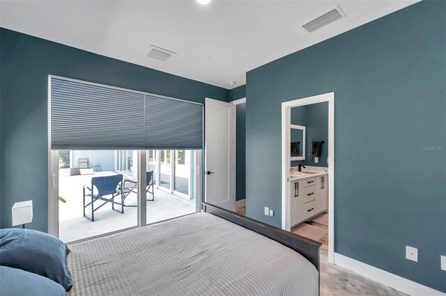 10722 Sumner Rd, Wimauma, FL 33598 - bedroom featuring access to exterior, a sink, baseboards, and connected bathroom