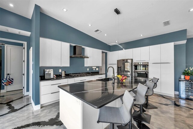 10722 Sumner Rd, Wimauma, FL 33598 - kitchen with wall chimney range hood, a sink, appliances with stainless steel finishes, dark countertops, and a breakfast bar