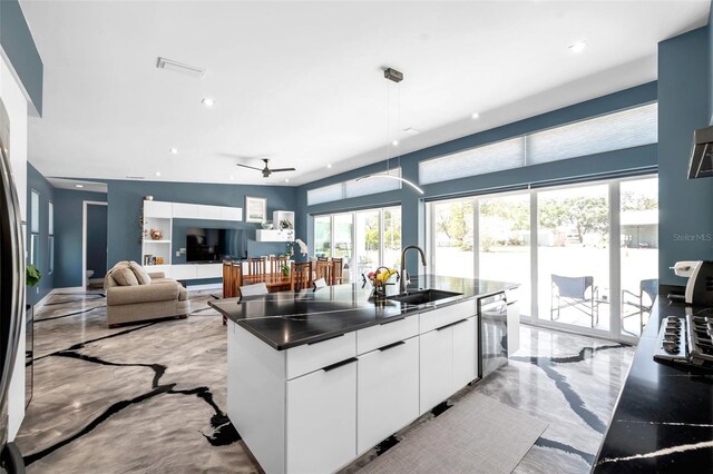 10722 Sumner Rd, Wimauma, FL 33598 - kitchen featuring light marble finish floors, a sink, white cabinetry, dark countertops, and modern cabinets