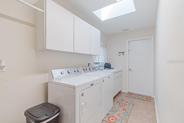 105 Douglas St, Homosassa, FL 34446 - washroom with cabinet space, a skylight, washer and dryer, baseboards, and light tile patterned floors