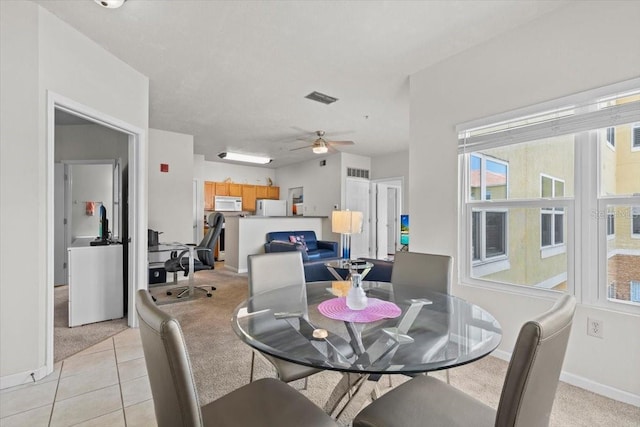 10764 70th Ave Unit 3206, Seminole, FL 33772 - dining space featuring light carpet, a ceiling fan, baseboards, and light tile patterned floors