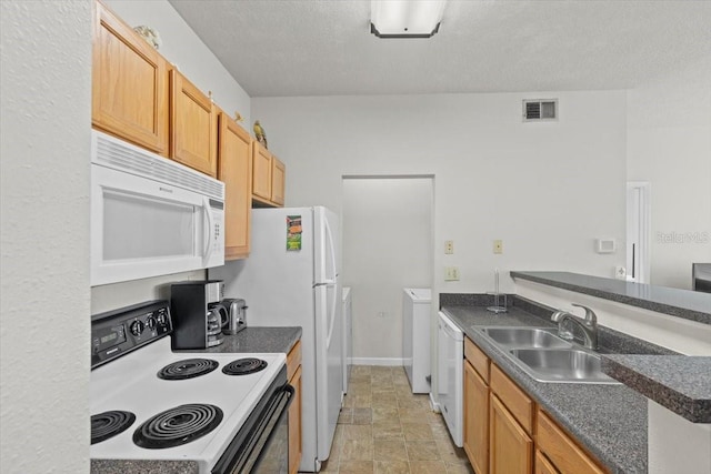 10764 70th Ave Unit 3206, Seminole, FL 33772 - kitchen with white appliances, dark countertops, a sink, baseboards, and a textured ceiling