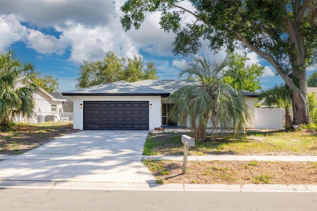 2436 Beacon Groves Blvd, Palm Harbor, FL 34683 - view of front of home with an attached garage, driveway, and brick siding