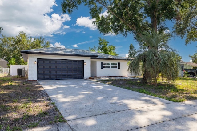 2436 Beacon Groves Blvd, Palm Harbor, FL 34683 - ranch-style house featuring brick siding, a garage, cooling unit, and concrete driveway