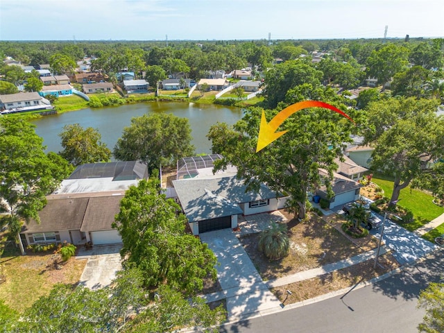 2436 Beacon Groves Blvd, Palm Harbor, FL 34683 - aerial perspective of suburban area featuring a nearby body of water and a tree filled landscape