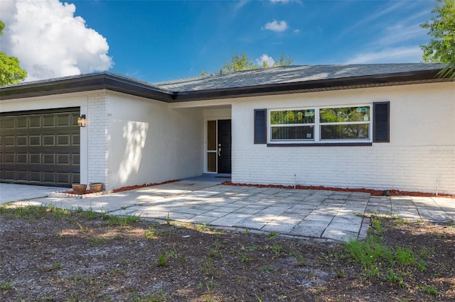 2436 Beacon Groves Blvd, Palm Harbor, FL 34683 - view of front of property featuring brick siding and an attached garage