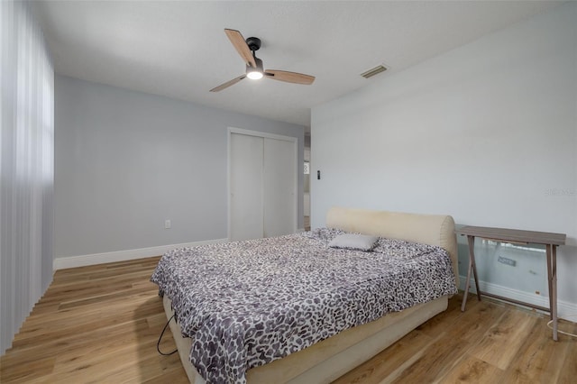 2436 Beacon Groves Blvd, Palm Harbor, FL 34683 - bedroom featuring light wood-type flooring, a closet, baseboards, and a ceiling fan