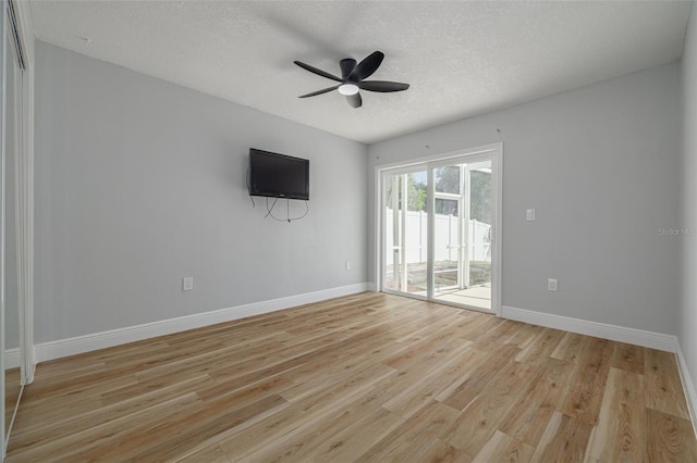 2436 Beacon Groves Blvd, Palm Harbor, FL 34683 - unfurnished room with ceiling fan, light wood-style floors, baseboards, and a textured ceiling