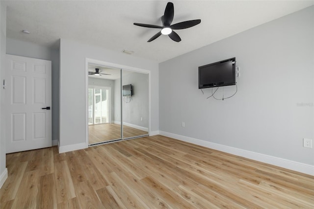 2436 Beacon Groves Blvd, Palm Harbor, FL 34683 - unfurnished bedroom with light wood-style floors, baseboards, a closet, and ceiling fan