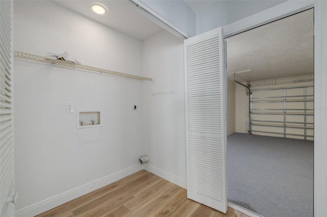 2436 Beacon Groves Blvd, Palm Harbor, FL 34683 - laundry room featuring hookup for an electric dryer, hookup for a washing machine, wood finished floors, and baseboards