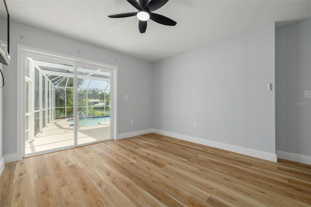 2436 Beacon Groves Blvd, Palm Harbor, FL 34683 - unfurnished room featuring a sunroom, a ceiling fan, and light wood finished floors