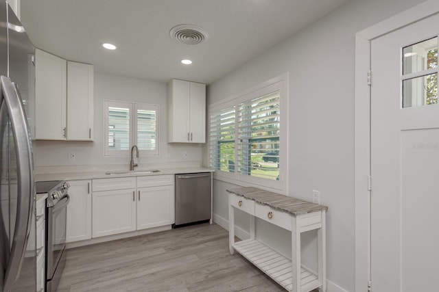 2271 Carolyn Dr, Dunedin, FL 34698 - kitchen featuring appliances with stainless steel finishes, a sink, plenty of natural light, light countertops, and recessed lighting