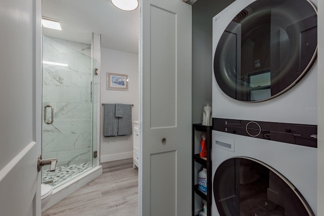 2271 Carolyn Dr, Dunedin, FL 34698 - washroom with stacked washer / dryer, light wood-style flooring, and baseboards