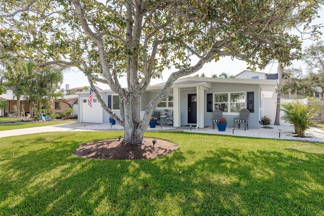 2271 Carolyn Dr, Dunedin, FL 34698 - ranch-style home featuring a front yard, concrete driveway, and stucco siding