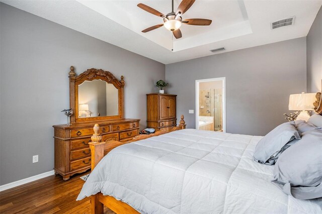 1524 Rhodeswell Ln, Dover, FL 33527 - bedroom featuring a raised ceiling, wood finished floors, baseboards, connected bathroom, and a ceiling fan