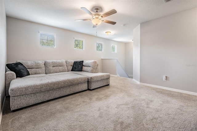 1524 Rhodeswell Ln, Dover, FL 33527 - living room featuring a ceiling fan, carpet floors, baseboards, and a textured ceiling