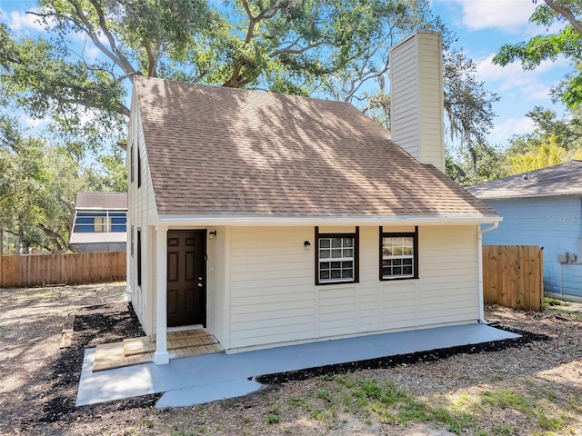 8521 N 29th St, Tampa, FL 33604 - view of front facade featuring a chimney and a shingled roof