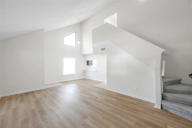 8521 N 29th St, Tampa, FL 33604 - additional living space featuring high vaulted ceiling, stairs, light wood-type flooring, and baseboards