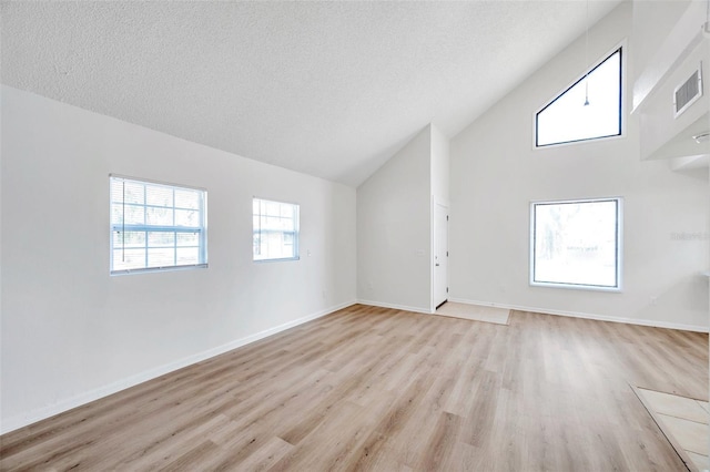 8521 N 29th St, Tampa, FL 33604 - bonus room featuring light wood finished floors, high vaulted ceiling, a textured ceiling, and baseboards