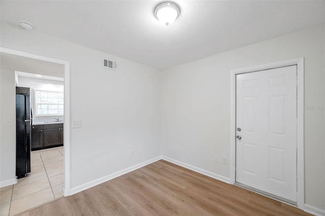 8521 N 29th St, Tampa, FL 33604 - empty room with light wood finished floors, baseboards, and a smoke detector